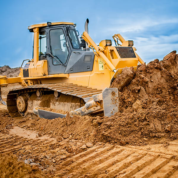Efficient earthmoving bulldozer clearing and levelling the construction site
